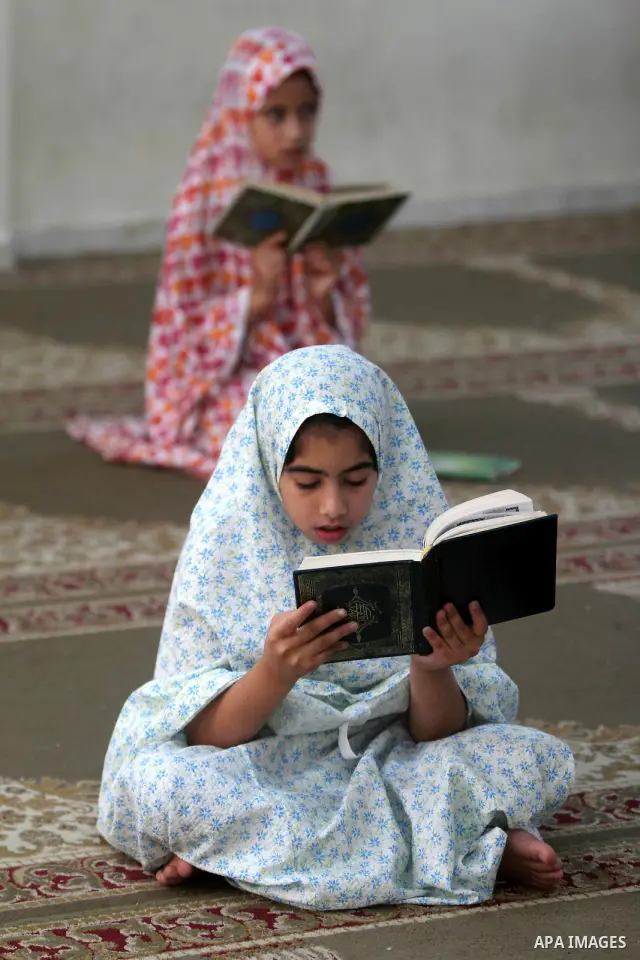 Palestinian girls read the Koran at a summer camp in the Gaza Strip, 04 July 2012. About 20,000 students, both male and female, study under the tuition of 1,200 teachers at the camp. Hamas usually isolates boys and girls...