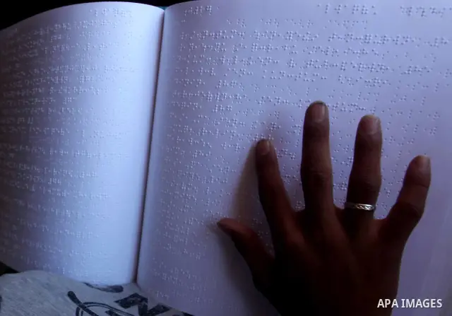 A blind Palestinian boy reads the Koran at a summer camp in the Gaza Strip, 04 July 2012. About 20,000 students, both male and female, study under the tuition of 1,200 teachers at the camp. Hamas usually isolates boys an...