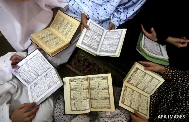 Palestinian girls read the Koran at a summer camp in the Gaza Strip, 04 July 2012. About 20,000 students, both male and female, study under the tuition of 1,200 teachers at the camp. Hamas usually isolates boys and girls...