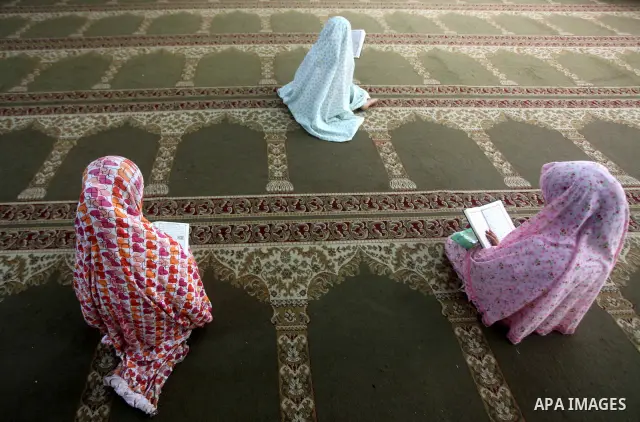 Palestinian girls read the Koran at a summer camp in the Gaza Strip, 04 July 2012. About 20,000 students, both male and female, study under the tuition of 1,200 teachers at the camp. Hamas usually isolates boys and girls...