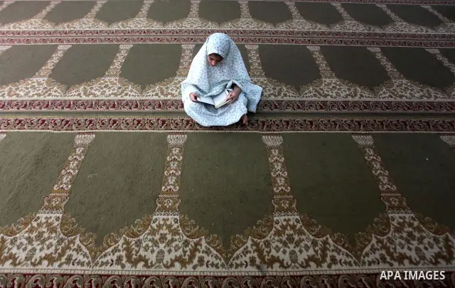 Palestinian girls read the Koran at a summer camp in the Gaza Strip, 04 July 2012. About 20,000 students, both male and female, study under the tuition of 1,200 teachers at the camp. Hamas usually isolates boys and girls...