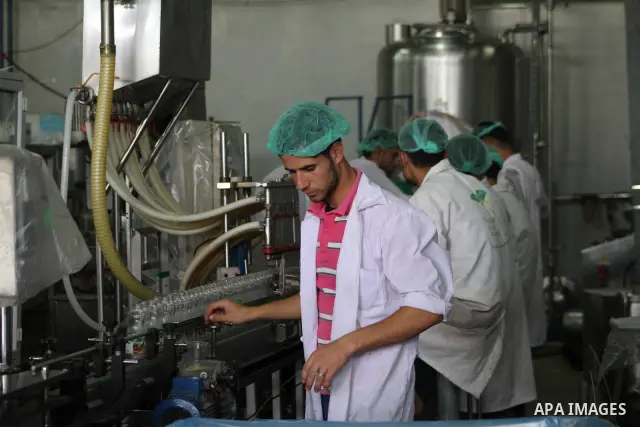 Palestinian workers bottle fruit juice at Juice Factory in Gaza City on July 5, 2011. it depends on citrus and fruit that are widely planted in Gaza Strip. Photo by Ashraf Amra