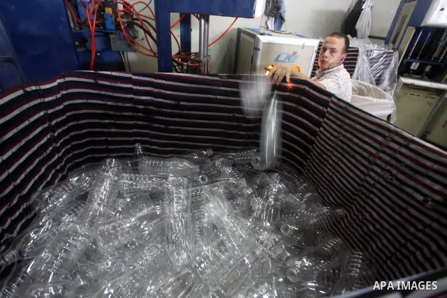 Palestinian workers bottle fruit juice at Juice Factory in Gaza City on July 5, 2011. it depends on citrus and fruit that are widely planted in Gaza Strip. Photo by Ashraf Amra