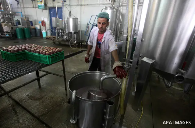 Palestinian workers bottle fruit juice at Juice Factory in Gaza City on July 5, 2011. it depends on citrus and fruit that are widely planted in Gaza Strip. Photo by Ashraf Amra