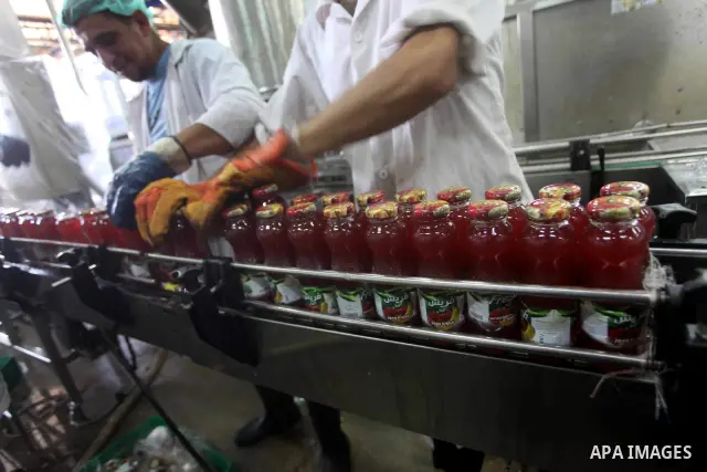 Palestinian workers bottle fruit juice at Juice Factory in Gaza City on July 5, 2011. it depends on citrus and fruit that are widely planted in Gaza Strip. Photo by Ashraf Amra