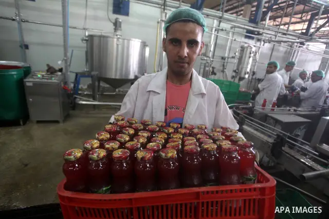 Palestinian workers bottle fruit juice at Juice Factory in Gaza City on July 5, 2011. it depends on citrus and fruit that are widely planted in Gaza Strip. Photo by Ashraf Amra