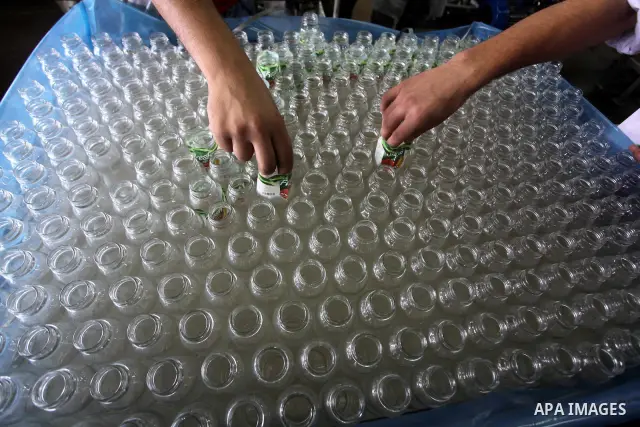 Palestinian workers bottle fruit juice at Juice Factory in Gaza City on July 5, 2011. it depends on citrus and fruit that are widely planted in Gaza Strip. Photo by Ashraf Amra