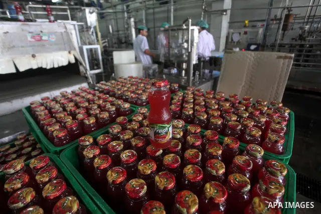 Palestinian workers bottle fruit juice at Juice Factory in Gaza City on July 5, 2011. it depends on citrus and fruit that are widely planted in Gaza Strip. Photo by Ashraf Amra