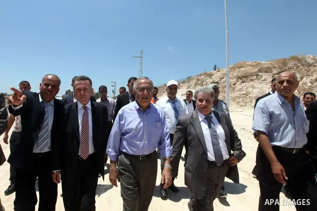 Palestinian Prime Minister Salam Fayyad puts the foundation stone of the infrastructure of the industrial ??craft area of in the neighborhood of Irtah, in the West Bank city of Tulkarm on 05 July 2012. Photo by Mustafa A...