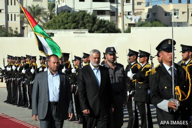 Palestinian Prime Minister in Gaza Ismail Haniye reviews a honor guard during a police officers graduation ceremony in Gaza City on July 05, 2012. A Palestinian official said Thursday, July 5, 2012 that Gaza's prime mini...