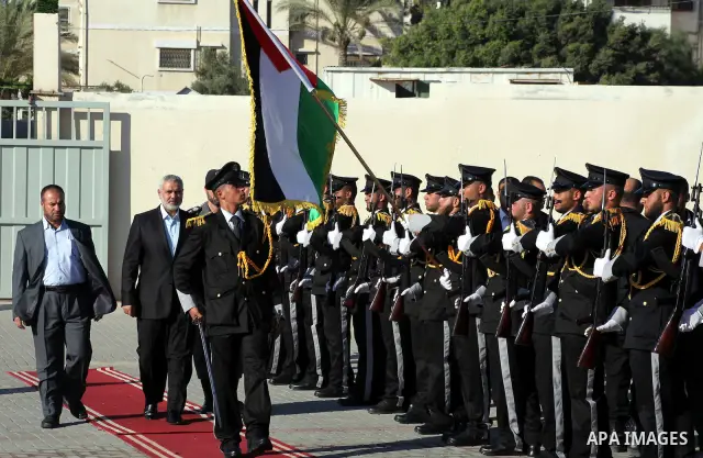 Palestinian Prime Minister in Gaza Ismail Haniye reviews a honor guard during a police officers graduation ceremony in Gaza City on July 05, 2012. A Palestinian official said Thursday, July 5, 2012 that Gaza's prime mini...