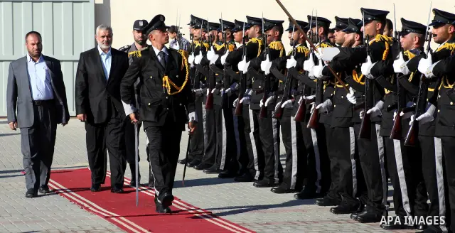 Palestinian Prime Minister in Gaza Ismail Haniye reviews a honor guard during a police officers graduation ceremony in Gaza City on July 05, 2012. A Palestinian official said Thursday, July 5, 2012 that Gaza's prime mini...