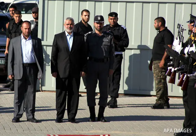 Palestinian Prime Minister in Gaza Ismail Haniye reviews a honor guard during a police officers graduation ceremony in Gaza City on July 05, 2012. A Palestinian official said Thursday, July 5, 2012 that Gaza's prime mini...