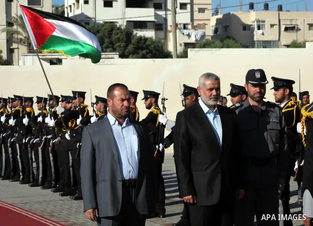 Palestinian Prime Minister in Gaza Ismail Haniye reviews a honor guard during a police officers graduation ceremony in Gaza City on July 05, 2012. A Palestinian official said Thursday, July 5, 2012 that Gaza's prime mini...