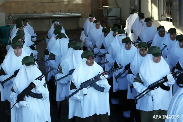 Female Hamas's police officers stand to attention during a ceremony in Gaza City on July 05, 2012. Hamas has governed the Gaza Strip since June 2007, after it won a majority of seats in the Palestinian Parliament in the...