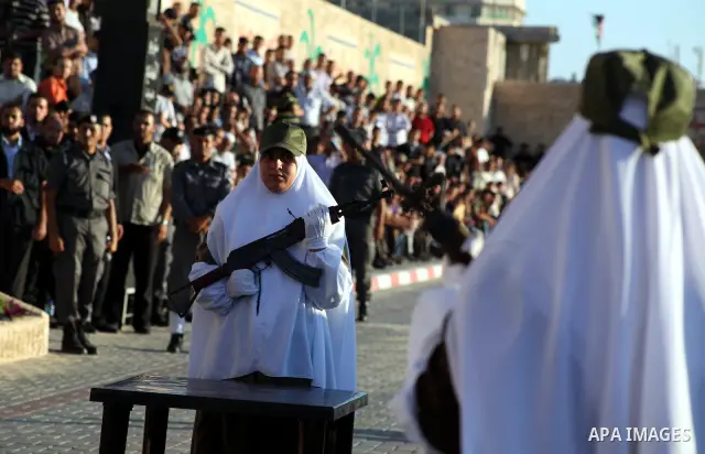 A female Hamas's police officer practices a weapon during a ceremony in Gaza City on July 05, 2012. Hamas has governed the Gaza Strip since June 2007, after it won a majority of seats in the Palestinian Parliament in the...