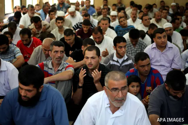 Palestinians listen to Palestinian Prime Minister in Gaza Ismail Haniyeh speech during Friday prayer in Deir al-Balah in the center of Gaza Strip on 06 July 2012. A Palestinian official said Thursday, July 5, 2012 that G...