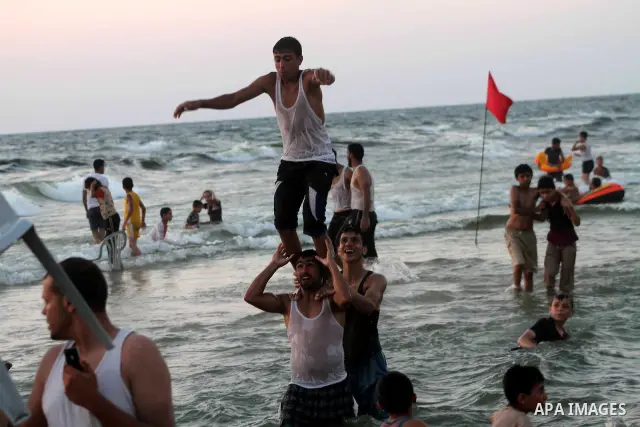 A Palestinian youth jumps into the Mediterranean sea on the beach of Gaza City, on July 06, 2012. Photo by Ashraf Amra