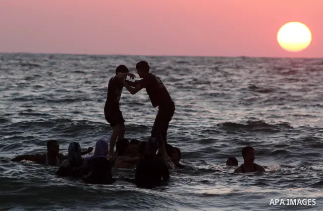 Palestinian youths jump into the Mediterranean sea on the beach of Gaza City, on July 06, 2012. Photo by Ashraf Amra