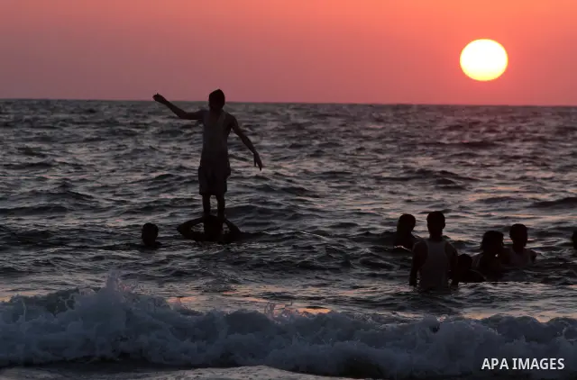 A Palestinian youth jumps into the Mediterranean sea on the beach of Gaza City, on July 06, 2012. Photo by Ashraf Amra