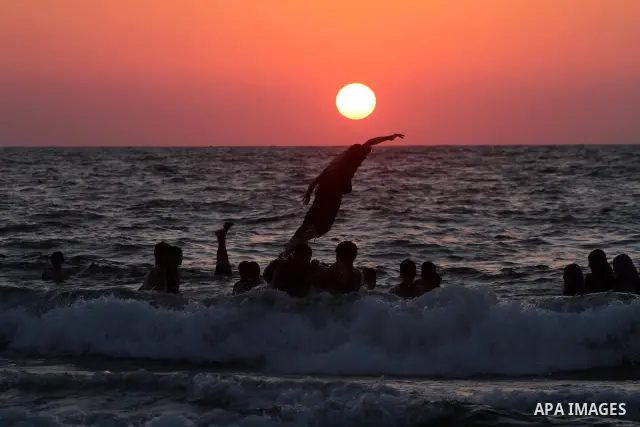 A Palestinian youth jumps into the Mediterranean sea on the beach of Gaza City, on July 06, 2012. Photo by Ashraf Amra