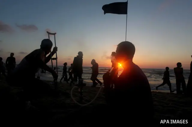 Palestinian youths smoke the water pipes on the beach on their week-end in the Mediterranean sea in Gaza City on July 06, 2012. Photo by Ashraf Amra
