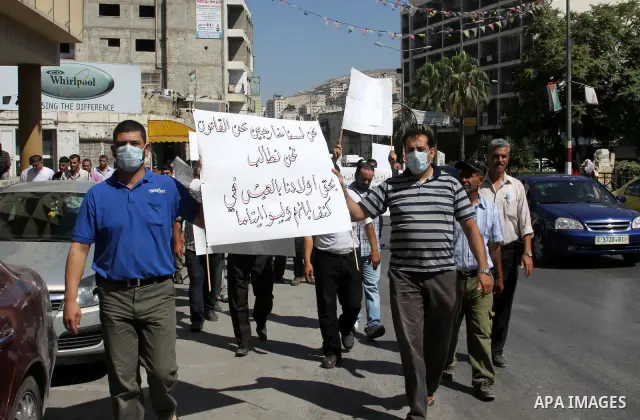 Palestinian demonstrators to calling of the justice and equality and the fight against corrupt during a march in the West Bank city of Nablus in, on July 07.07 2012. Photo by Nedal Eshtayah