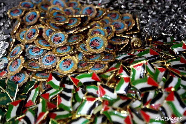 Palestinian vendor displays merchandise with pictures of the late Palestinian leader Yasser Arafat in Gaza City on July 7, 2012. Arafat, who died in 2004, was poisoned by polonium, according to the findings of laboratory...