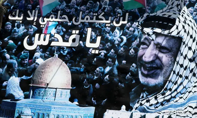 A huge poster of late Palestinian leader Yasser Arafat with al-Aqsa mosque in Gaza City on July 7, 2012. The Palestinian National Authority (PNA) has agreed to exhume late President Yasser Arafat's body for examination u...