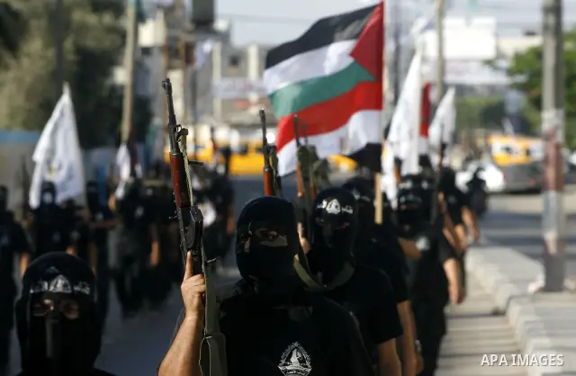 Militants from the Palestinian al-Ahrar Brigade march during a ceremony for the fifth anniversary of their inception in the southern Gaza Strip town of Rafah on July 7, 2012.. Photo by Eyad Al Baba. Photo by Eyad Al Baba