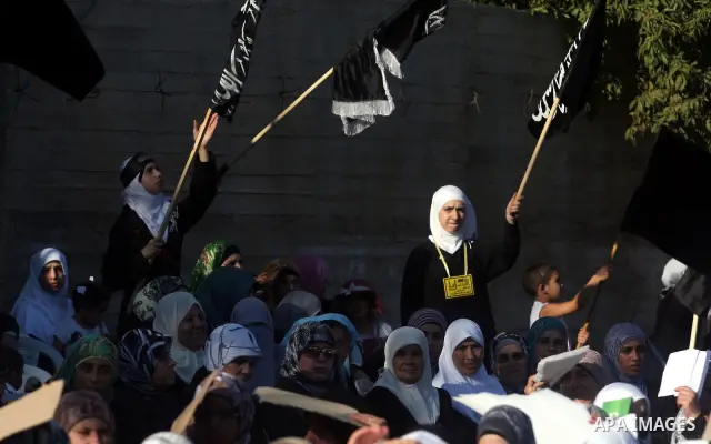 Palestinian supporters of Hizb ut-Tahrir or the Islamic Liberation Party, chant slogans and wave black and white flags with the religous writing "There is no God but God, and Mohammed is his prophet" during a rally in th...