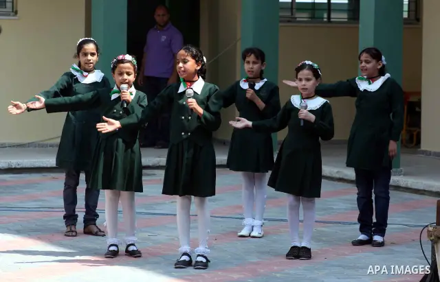 Palestinian students sing during presence of Palestinian Prime Minister in Gaza Ismail Haniyeh in the opening of a new school in Zaytoon neighborhood Gaza city on 08 July 2012. A Palestinian official says Gaza's prime mi...
