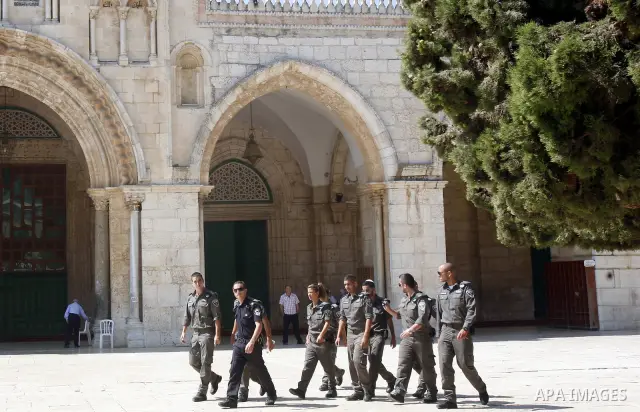 Israeli soldiers walk past the Al-Aqsa mosque compound, Islam's third holiest site, during a visit under Israeli police protection in Jerusalem's Old City on July 08, 2012. Photo by Mahfouz Abu Turk