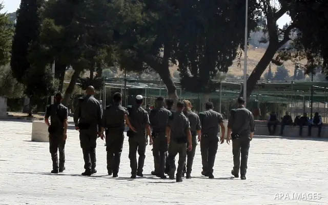 Israeli soldiers walk past the Al-Aqsa mosque compound, Islam's third holiest site, during a visit under Israeli police protection in Jerusalem's Old City on July 08, 2012. Photo by Mahfouz Abu Turk