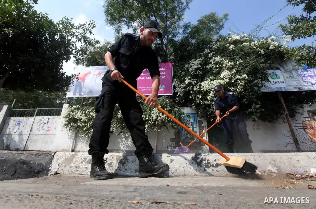 Palestinian officers participate in cleaning streets during a campaign organized by ministry of Labor, in Gaza city on July 09 2012. Photo by Majdi Fathi