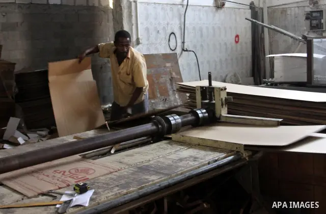 Palestinian labourers work at a factory for making a carton in the West Bank city of Nablus on July 09, 2012. Photo by Nedal Eshtayah