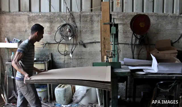 Palestinian labourers work at a factory for making a carton in the West Bank city of Nablus on July 09, 2012. Photo by Nedal Eshtayah
