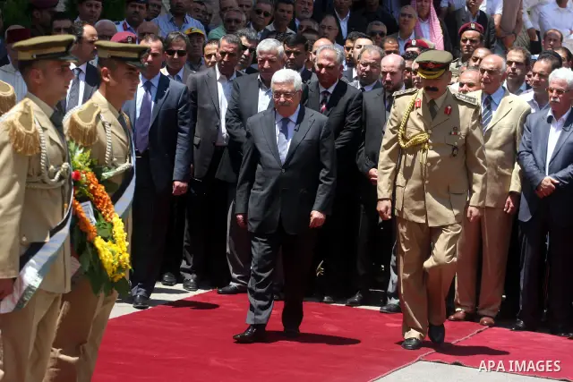 Palestinian President Mahmud Abbas attends the funeral of Hani al-Hassan, who was a close aide of Palestinian late leader, Yasser Arafat, as soldiers carry his coffin during his funeral procession in the West Bank city o...