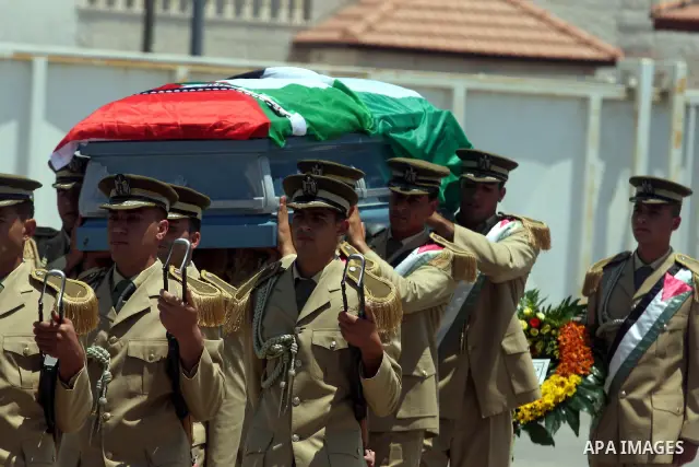 Palestinian soldiers carry the coffin of Hani al-Hassan, who was a close aide to Palestinian late leader, Yasser Arafat, during his funeral procession in the West Bank city of Ramallah on July 9, 2012. Hassan died on Jul...