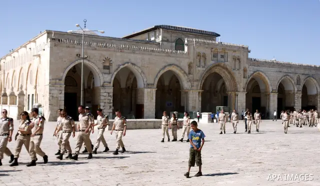 Israeli soldiers walk past the Al-Aqsa mosque compound, Islam's third holiest site, during a visit under Israeli police protection in Jerusalem's old city on July 09, 2012. Photo by Mahfouz Abu Turk