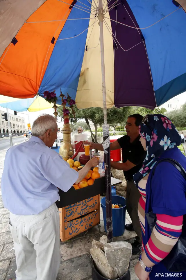 Palestinian vendor sells natural juice and drinks at the market in Jerusalem's old city on July 09, 2012. Photo by Mahfouz Abu Turk