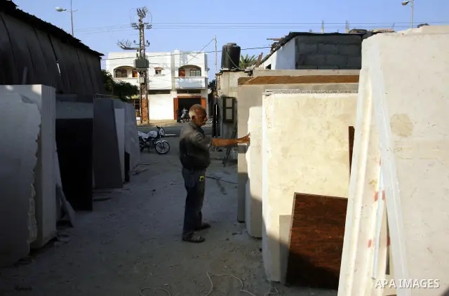 A Palestinian labourer works at a marble workshop for in Rafah in southern Gaza strip on July 09, 2012. Photo by Eyad Al Baba