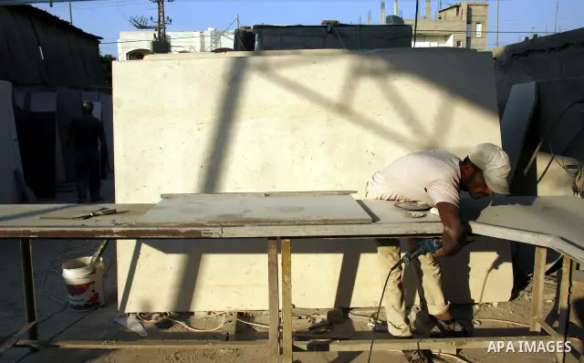 A Palestinian labourer works at a marble workshop for in Rafah in southern Gaza strip on July 09, 2012. Photo by Eyad Al Baba