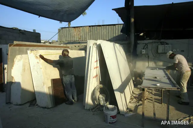 Palestinian labourers work at a marble workshop for in Rafah in southern Gaza strip on July 09, 2012. Photo by Eyad Al Baba