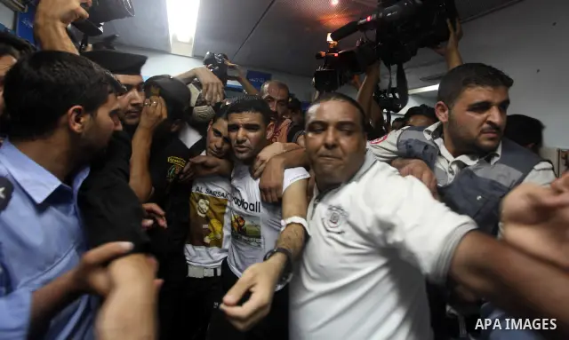 Palestinian soccer player Mahmoud Al-Sarsak waves to people upon his arrival in Gaza City July 10, 2012. Israel released the Gaza soccer player on Tuesday in a deal to end his intermittent four-month hunger strike after...