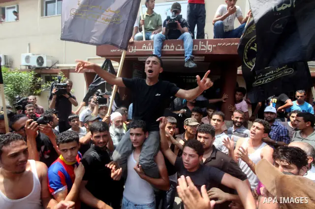 Palestinians celebrate during Palestinian soccer player Mahmoud Al-Sarsak arrives in Gaza City July 10, 2012. Israel released the Gaza soccer player on Tuesday in a deal to end his intermittent four-month hunger strike a...