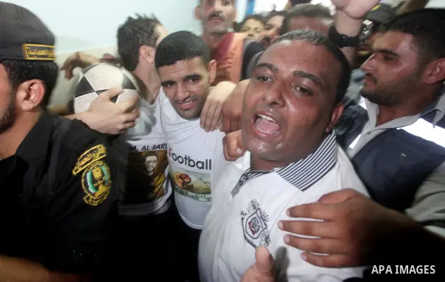 Palestinian soccer player Mahmoud Al-Sarsak waves to people upon his arrival in Gaza City July 10, 2012. Israel released the Gaza soccer player on Tuesday in a deal to end his intermittent four-month hunger strike after...