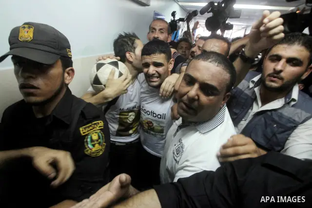 Palestinian soccer player Mahmoud Al-Sarsak waves to people upon his arrival in Gaza City July 10, 2012. Israel released the Gaza soccer player on Tuesday in a deal to end his intermittent four-month hunger strike after...