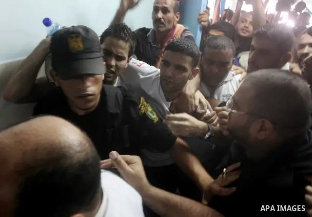 Palestinian soccer player Mahmoud Al-Sarsak waves to people upon his arrival in Gaza City July 10, 2012. Israel released the Gaza soccer player on Tuesday in a deal to end his intermittent four-month hunger strike after...