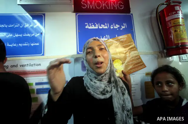 Palestinian woman reacts while Palestinian soccer player Mahmoud Al-Sarsak arrives in Gaza City July 10, 2012. Israel released the Gaza soccer player on Tuesday in a deal to end his intermittent four-month hunger strike...
